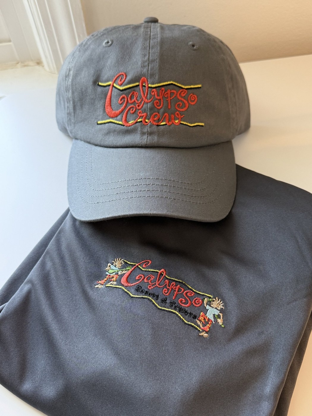 Grey cap and shirt with colorful embroidered logos